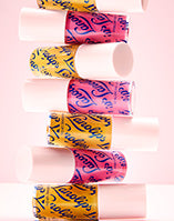 Lanolips Lip Oil Honey and Raspberry tubes stacked on top of each other.