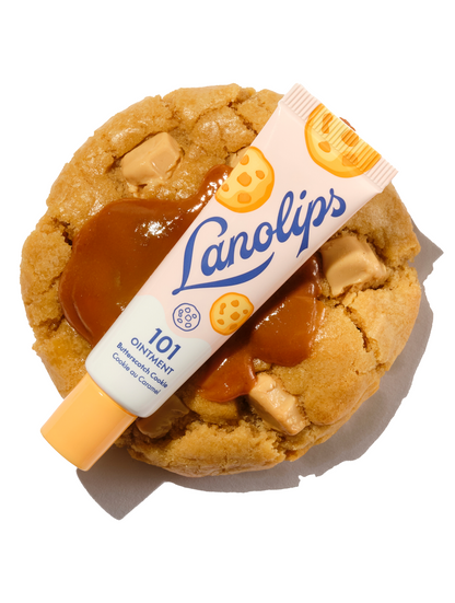 Lanolips 101 Multi-Balm Ointment in Butterscotch Cookie flavour, part of the 101 Delicious collection. The 100% natural lanolin tube is placed over a thick, freshly baked biscuit topped with golden, gooey caramel for deep, lips-loving hydration.
