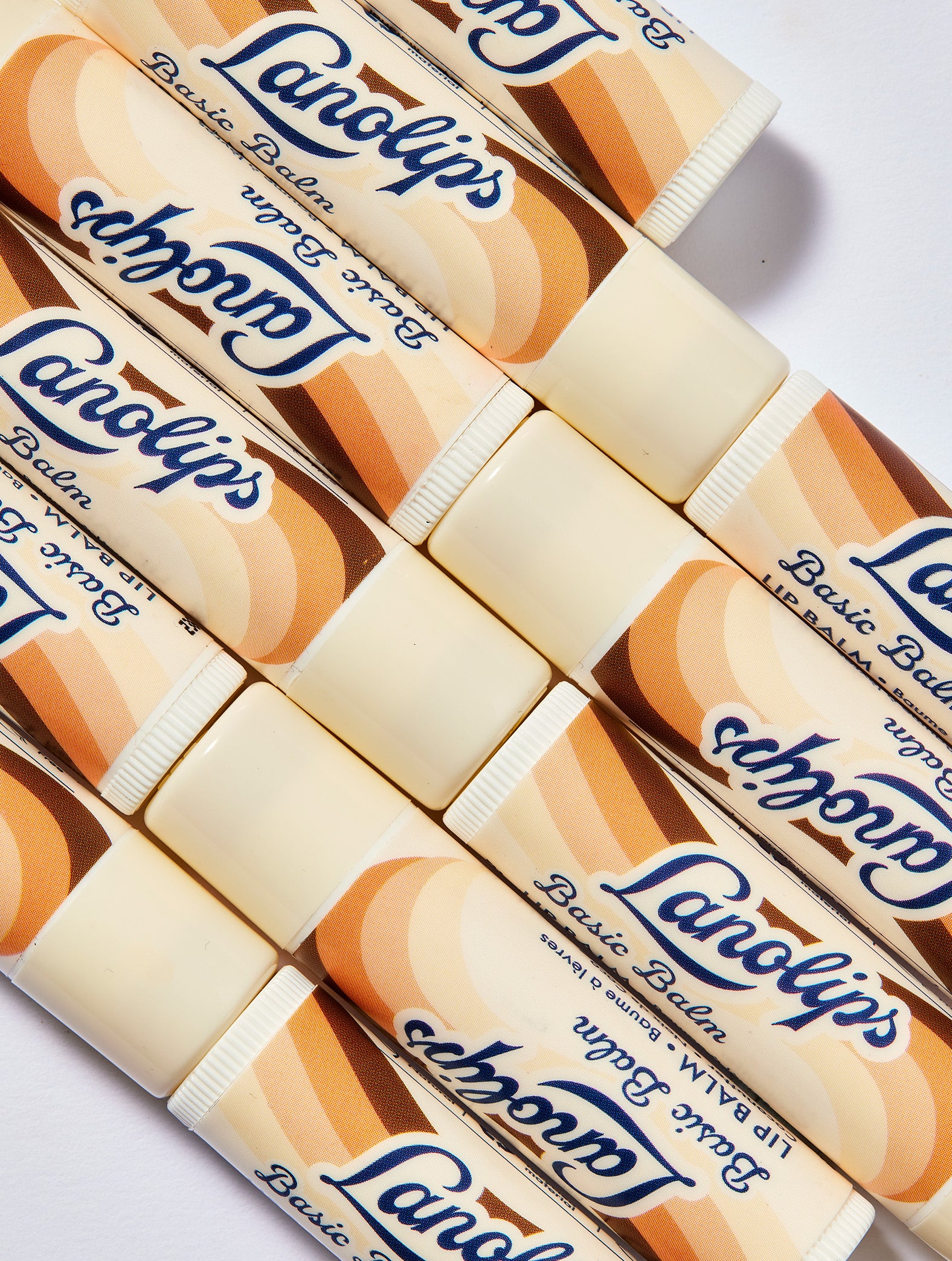 Multiple tubes of the Lanolips Basic Balm Coconutter placed against a white background.