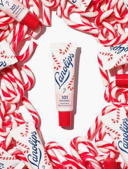 Lanolips 101 Ointment Multi-Balm Candy Cane tube surrounded by candy canes on a white background.