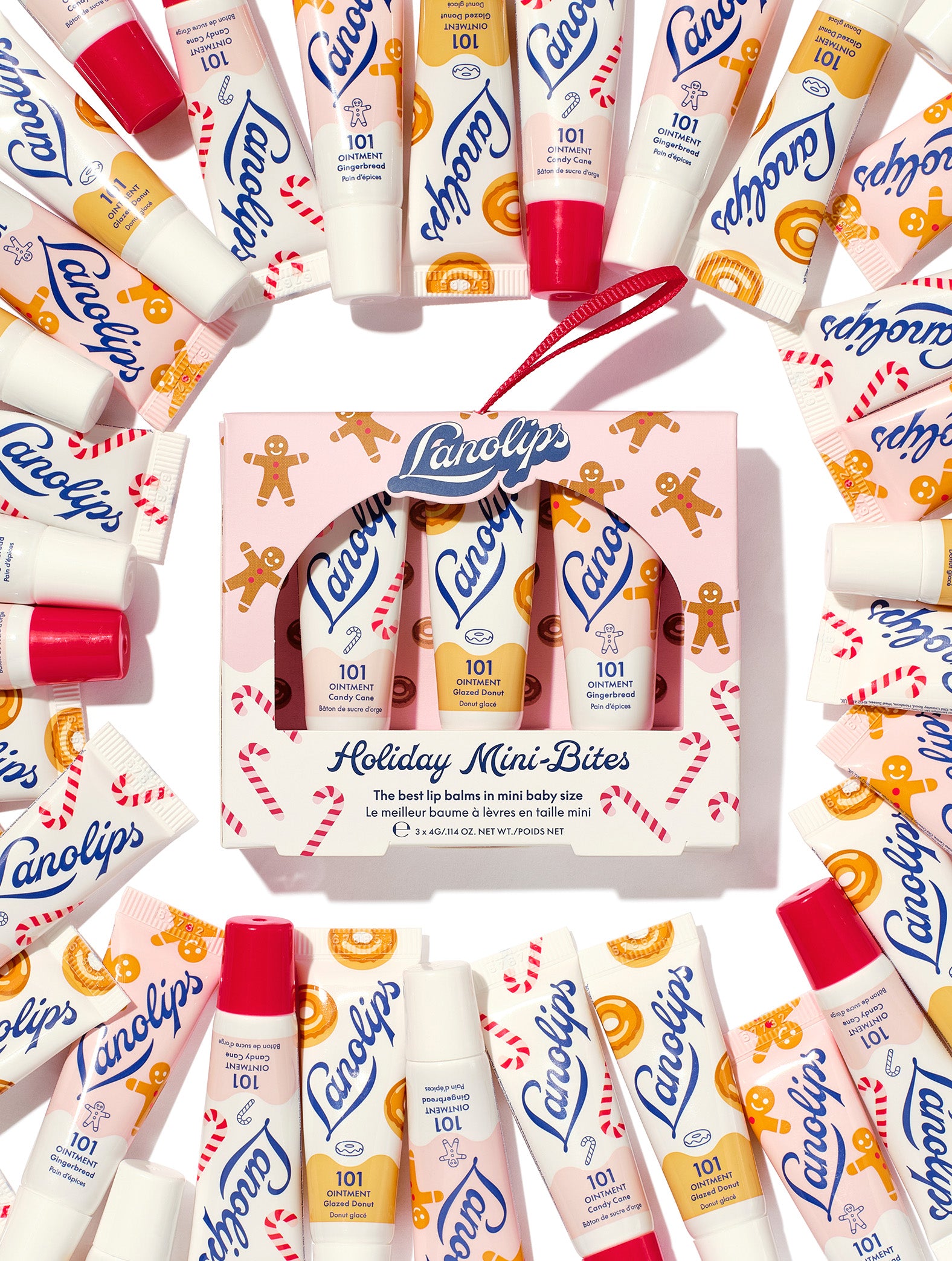 Lanolips Holiday Mini Bites lip balm gift set surrounded by tubes in Candy Cane, Gingerbread and Glazed Donut flavours, packed with rich lanolin, vitamin E and natural flavours, a holiday festive twist.