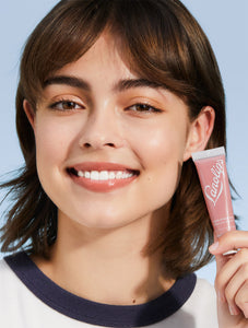 Model wearing Lanolips Tinted Lip Balm SPF30 in Perfect Nude is a universally flattering nude tint