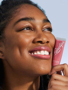 Model wearing Tinted Lip Balm SPF30 in Rhubarb brightens up your natural lip colour
