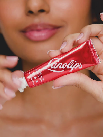 A video of a model applying and wearing Lanolips Rose Gold 101 Ointment, unveiling a dense, rich rose gold tint that enhances lips and cheeks with a natural, flushed glow. The ultra-hydrating formula delivers a dewy, non-sticky finish, mimicking the effect of blood rushing to the skin for a healthy, radiant look.