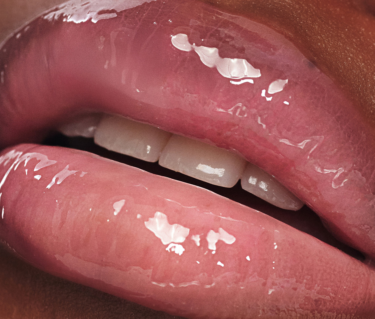 Macro close-up of smooth, glossy lips with Lanolips Milkshake Ceramide Balm in Raspberry Crumble, showing a hydrated finish and sheer raspberry tint