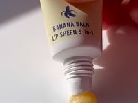 Video of Lanolips Banana Balm Lip Sheen 3-in-1 being squeezed from the tube