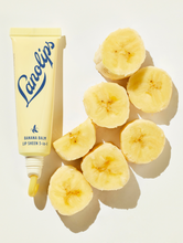 Lifestyle shot of Lanolips Banana Balm Lip Sheen 3-in-1 with cut up bananas