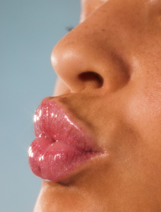 Close up shot of model wearing Lanolips Liquid Lip Water
