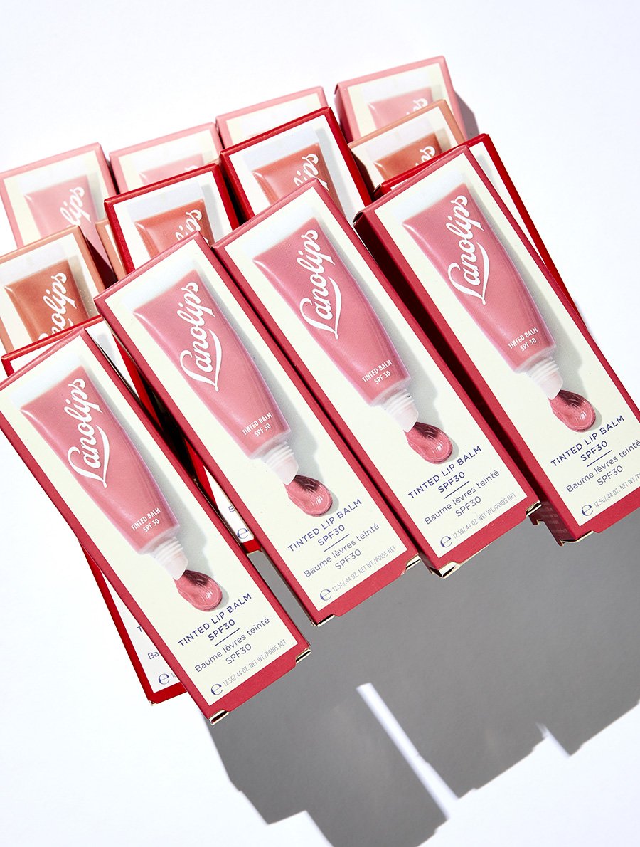 Boxes of the Lanolips Tinted Lip Balm SPF30 range
