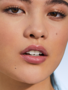 Model with Tinted Lip Balm in Rose, a creamy rose-tea sheen.